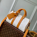 LOUIS VUITTON KEEPALL BANDOULIÈRE 25 IN WHITE MONOGRAM HERITAGE CANVAS BRWON CALFSKIN