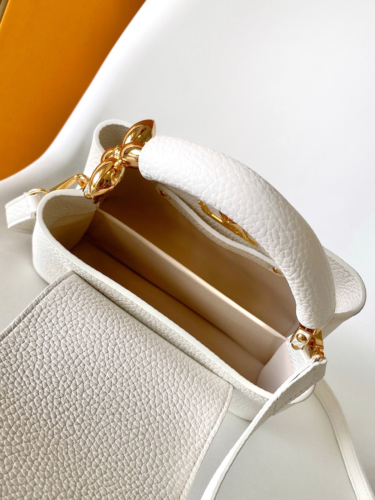 LOUIS VUITTON CAPUCINES EAST-WEST MINI 21 IN WHITE TAURILLON LEATHER GOLD-TONE HARDWARE
