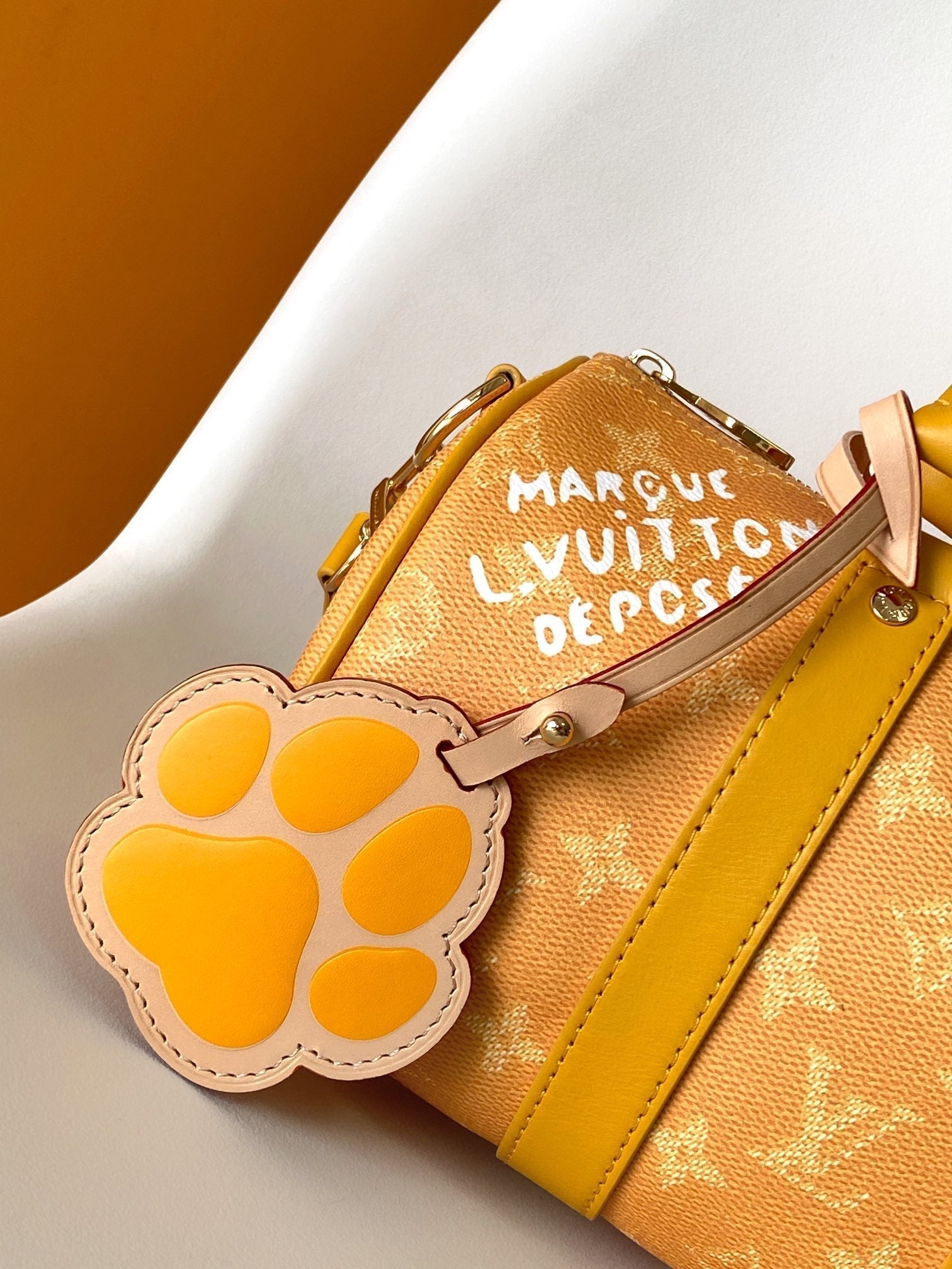 LOUIS VUITTON KEEPALL BANDOULIÈRE 25 IN ORANGE MONOGRAM HERITAGE CANVAS